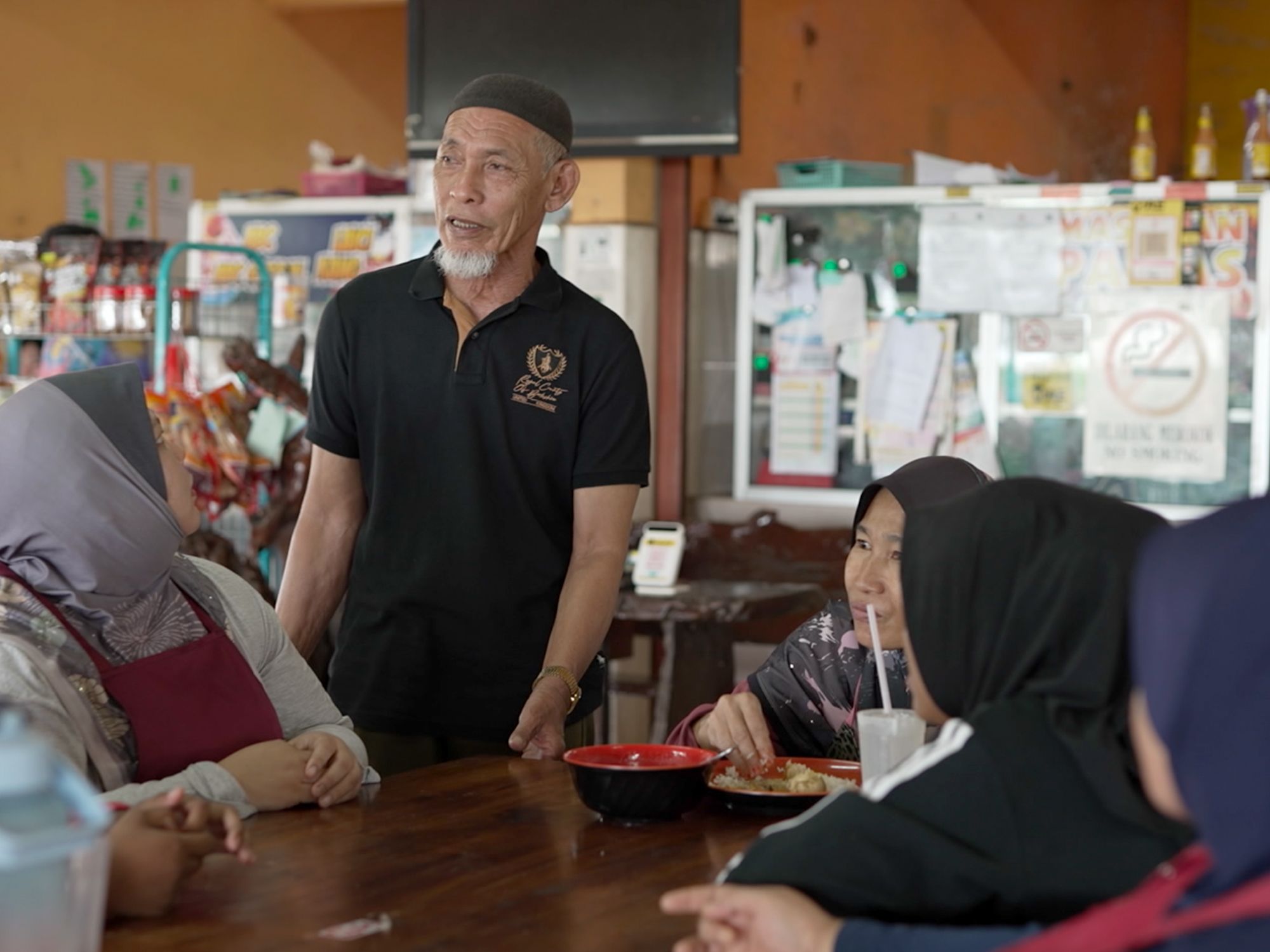 Ahmad and his staff chatting at his restaurant.